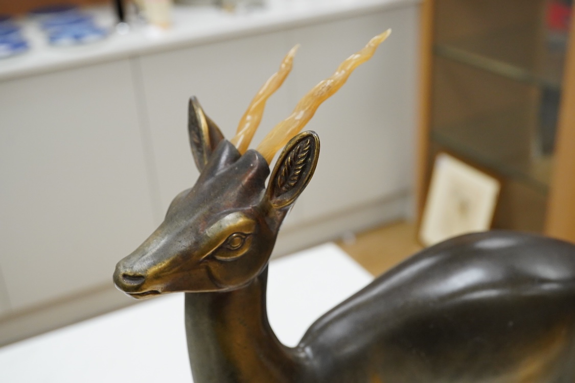 An Art Deco spelter and marble stag and deer group, 70cm wide